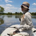 Girl fishing from boat at Koster Dam