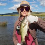 Girl holding nice bass caught while fishing at Mearns Dam