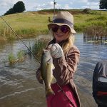 Girl with bass caught while fishing at Mearns Dam