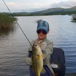 Girl holding nice bass caught while fishing at Mearns Dam