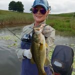 Girl holding nice bass caught while fishing at Mearns Dam